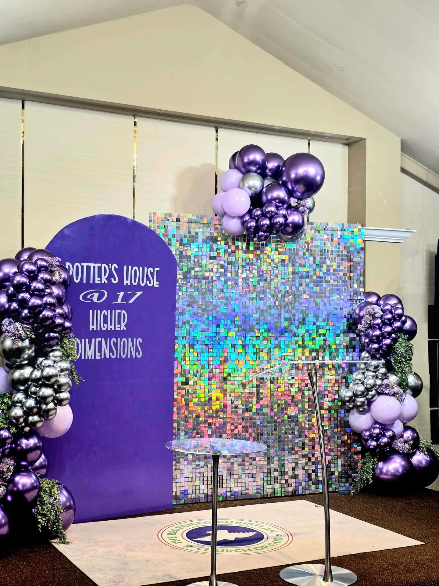 Purple and silver balloon garland with a holographic sequin wall